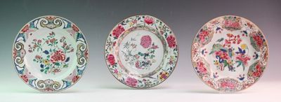 three plates with floral designs on them sitting next to each other