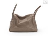 an image of a brown leather handbag sitting on top of a white surface