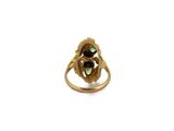 an image of a gold ring with a green stone in the center