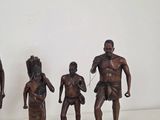 three bronze figurines of a man and a woman and a child