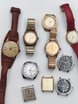 a lot of watches that are sitting on a table
