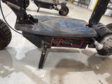 a scooter that is sitting on the ground in a garage