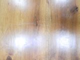 a close up of a wooden table with a clock on it