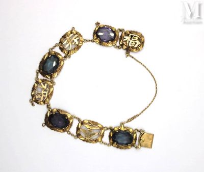 an image of a close up of a bracelet on a white surface