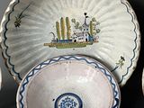 a group of plates and bowls with designs on them