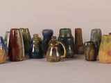 a lot of vases that are sitting on a table