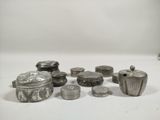 a lot of silver objects sitting on a white surface