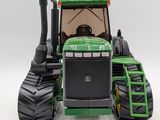 a toy tractor that is sitting on a white surface