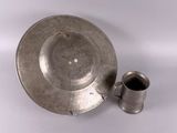 a silver plate with a cup and saucer on it