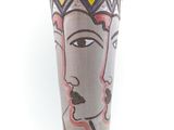 un vase sur lequel est peint le visage d'une femme