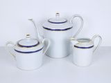 three pieces of white and blue tea set with gold trim