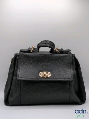 a black leather handbag with gold hardware on the handle