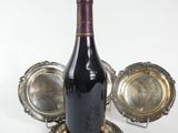 a bottle of wine that is sitting on a silver tray