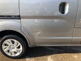a silver van parked in a parking lot with its door open