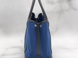 a blue bag with a zipper on the front and a black handle