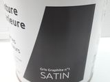 a can of satin paint on a white table