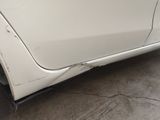 a white car with a hole in the side of it
