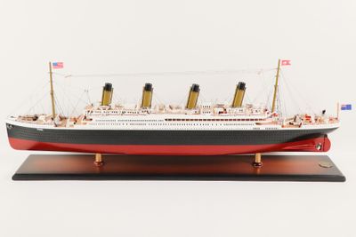 a model of a large ship on a wooden stand