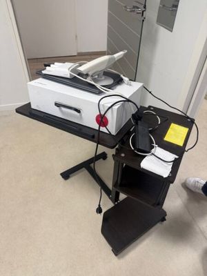a printer sitting on top of a stand in a room