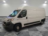 la camionnette blanche est garée sur un sol carrelé en damier