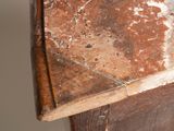 a small wooden table with a marble top