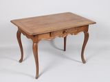 an old wooden table with a drawer on top of it