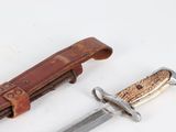 a knife that is laying next to a knife holder