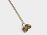 a gold necklace with a heart shaped pendant on a chain