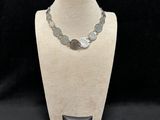a necklace and bracelet set on a mannequin stand