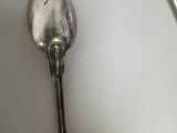 a silver spoon and a silver spoon on a table