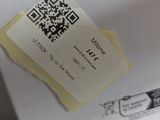 a person holding a piece of paper with a qr code on it