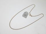 a close up of a necklace with a tag on it