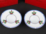 two small plates with christmas decorations on them sitting next to a red box