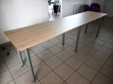 a wooden table with metal legs on a tiled floor