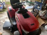 a red lawn mower parked in a garage