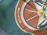 a close up of a green and brown umbrella with a yellow wheel