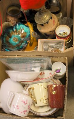 a box full of dishes and cups on the floor