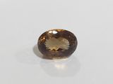 a brown and white gemstone on a white surface