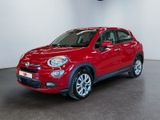 the red fiat suv is parked in a large room