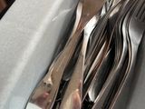 a lot of silverware in a bowl with a spoon and a knife