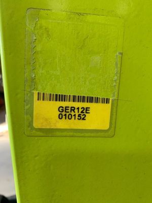 a green parking meter with a barcode on it