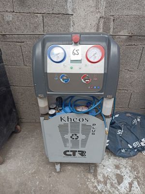 a machine that is sitting on the ground next to a trash can