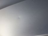 the front bumper of a car with a dent on it
