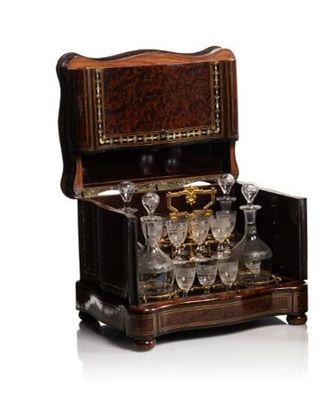 a wooden box with a wine glass set inside of it