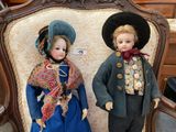 two dolls that are standing next to each other