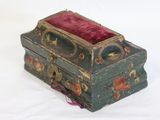 a small green box with a red velvet lining