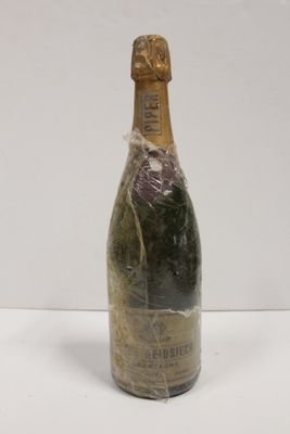 a close up of a bottle of champagne on a white surface