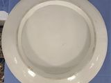 a white plate sitting on a blue napkin on a table