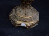 a gold vase sitting on top of a black table