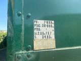 a sign on the back of a green truck